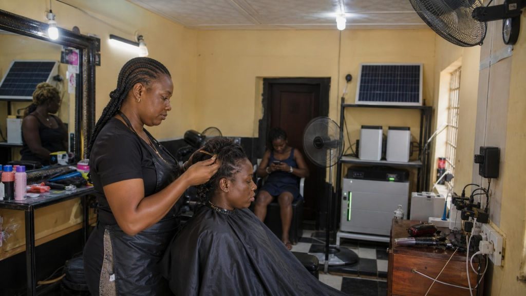 A small Nigerian salon using solar backup for lights, fans and clippers during a power outage.